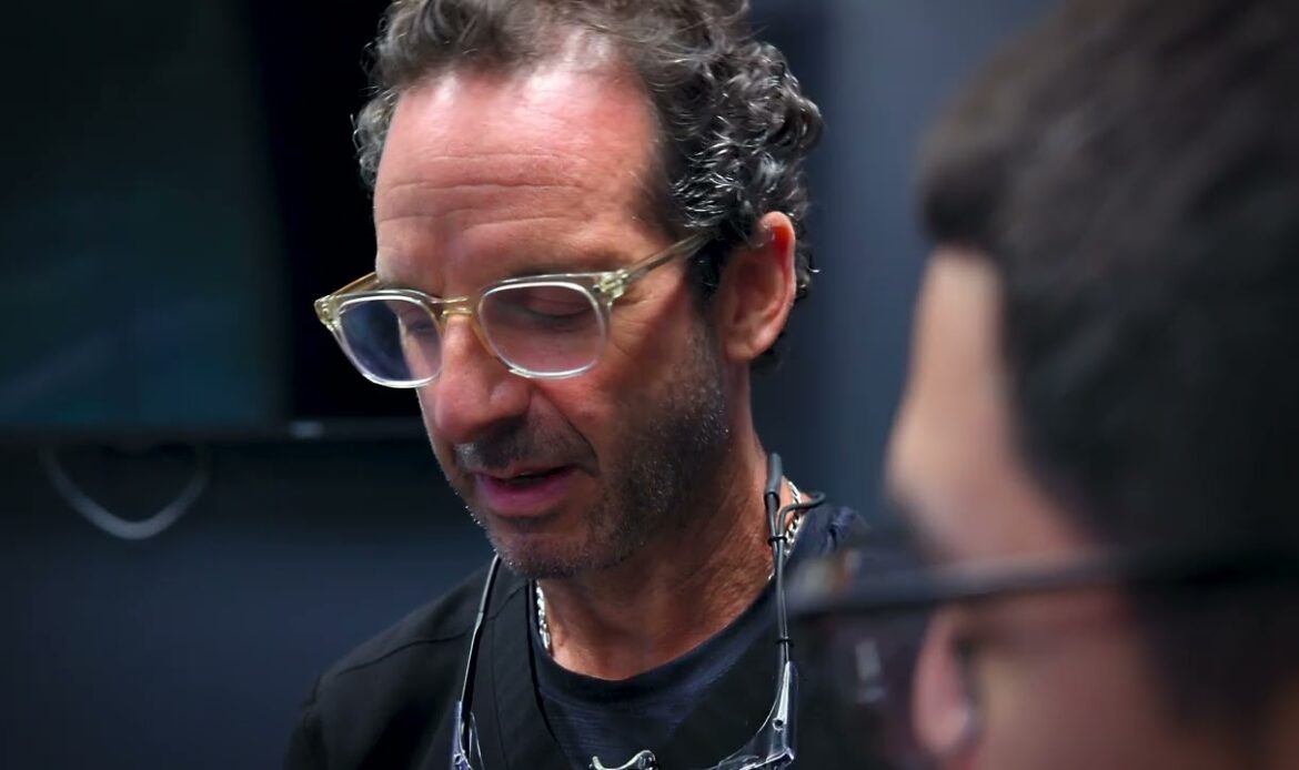 Dr. Jon Robert Friedberg, Houston periodontist, talking with a patient