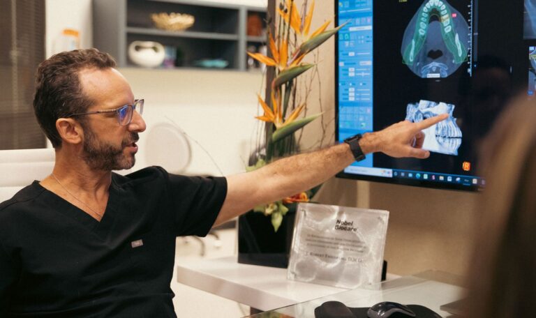 Dental implants Houston periodontist Dr. Friedberg reviewing scan with patient during consultation