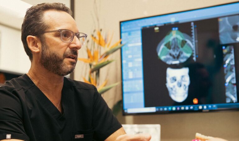 Dr. Friedberg reviewing 3D dental implant scan on screen at Houston office