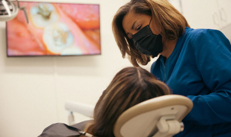 Dental hygienist preparing patient for treatment at Dr. Friedberg & Associates in Houston