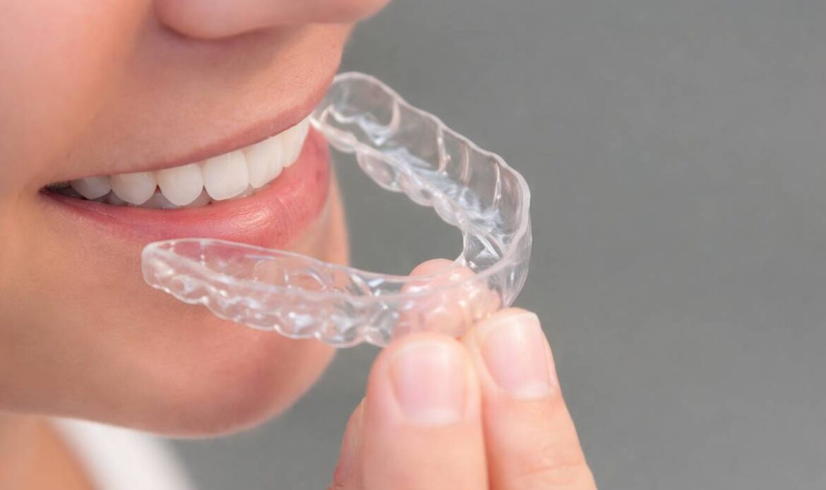Clear dental retainer worn after braces to keep teeth straight