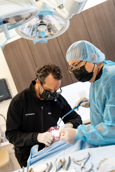 dentist examining gums for gum disease without pain