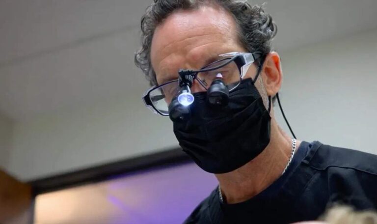 Dental implant specialist evaluating a failed dental implant treatment case